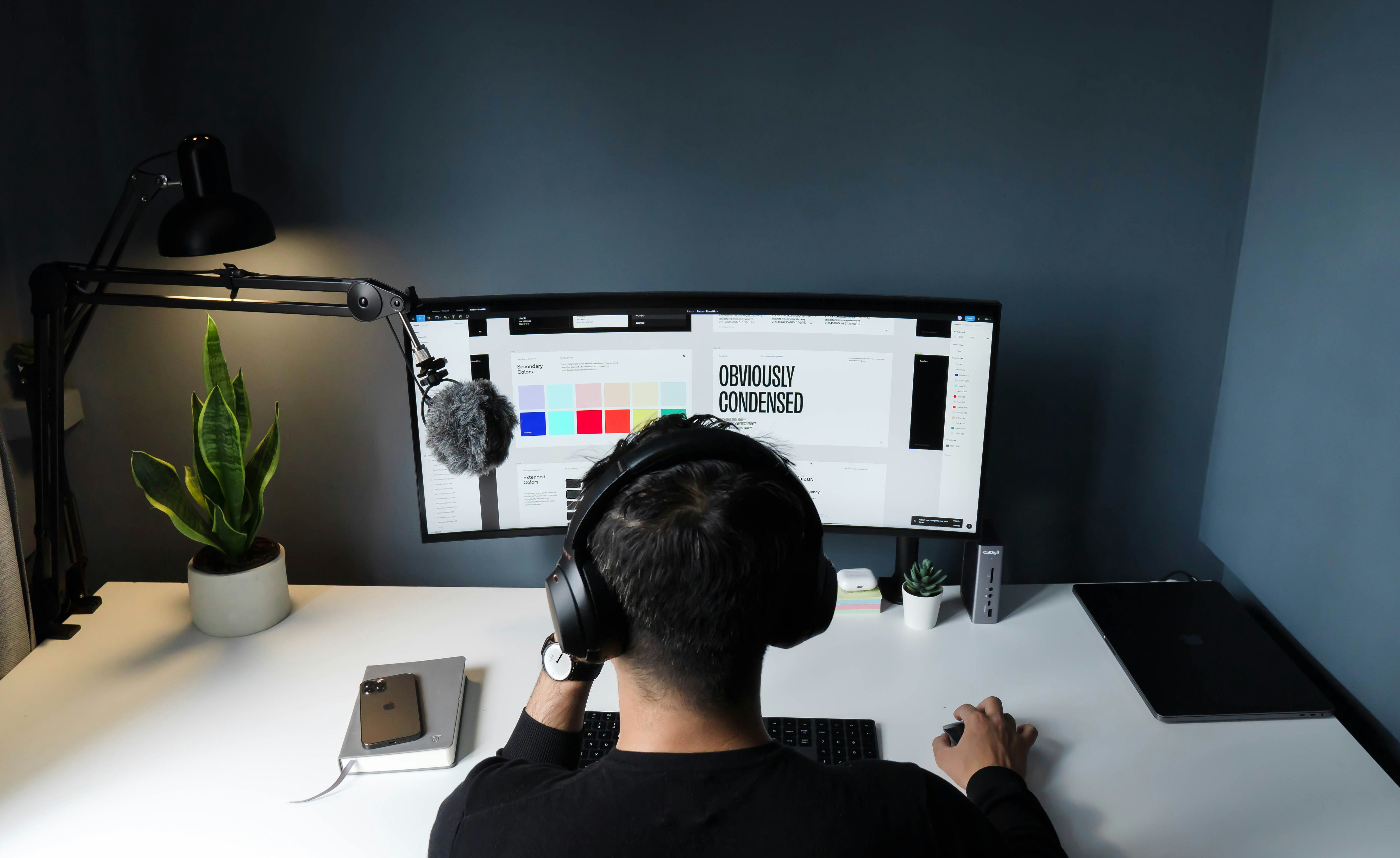 Designer at a workstation building a client website in FD Webworks' studio